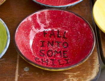 festive bowl that says Fall Into Some Chili on the bottom of it