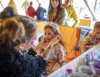 kid getting their face painted 