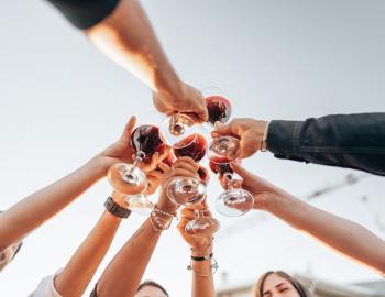 Group of friends toasting at a wine festival