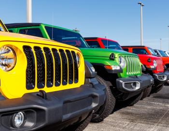 A row of multi-color jeeps side by side.