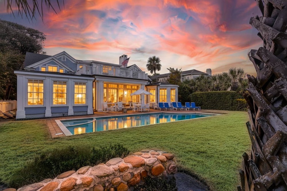 Vacation rental home backyard with private pool and outdoor dining area