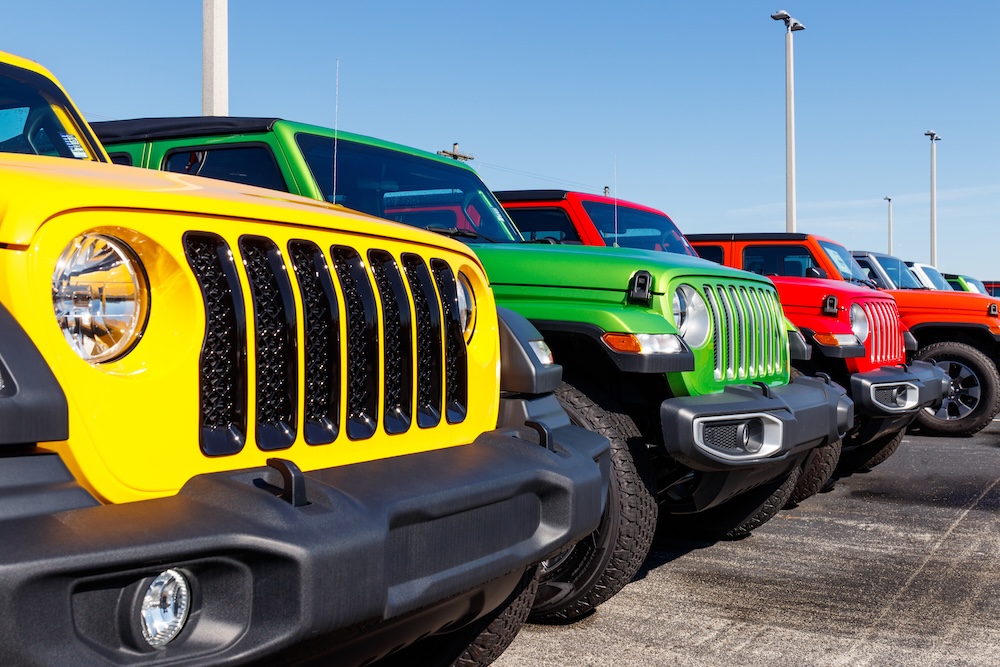 A row of multi-color jeeps side by side.